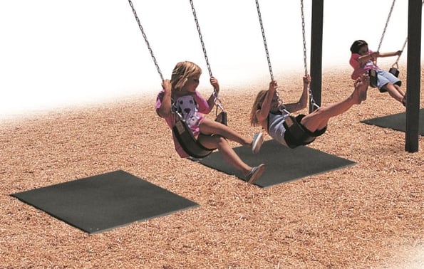 Kids on swings with rubber mats under swings